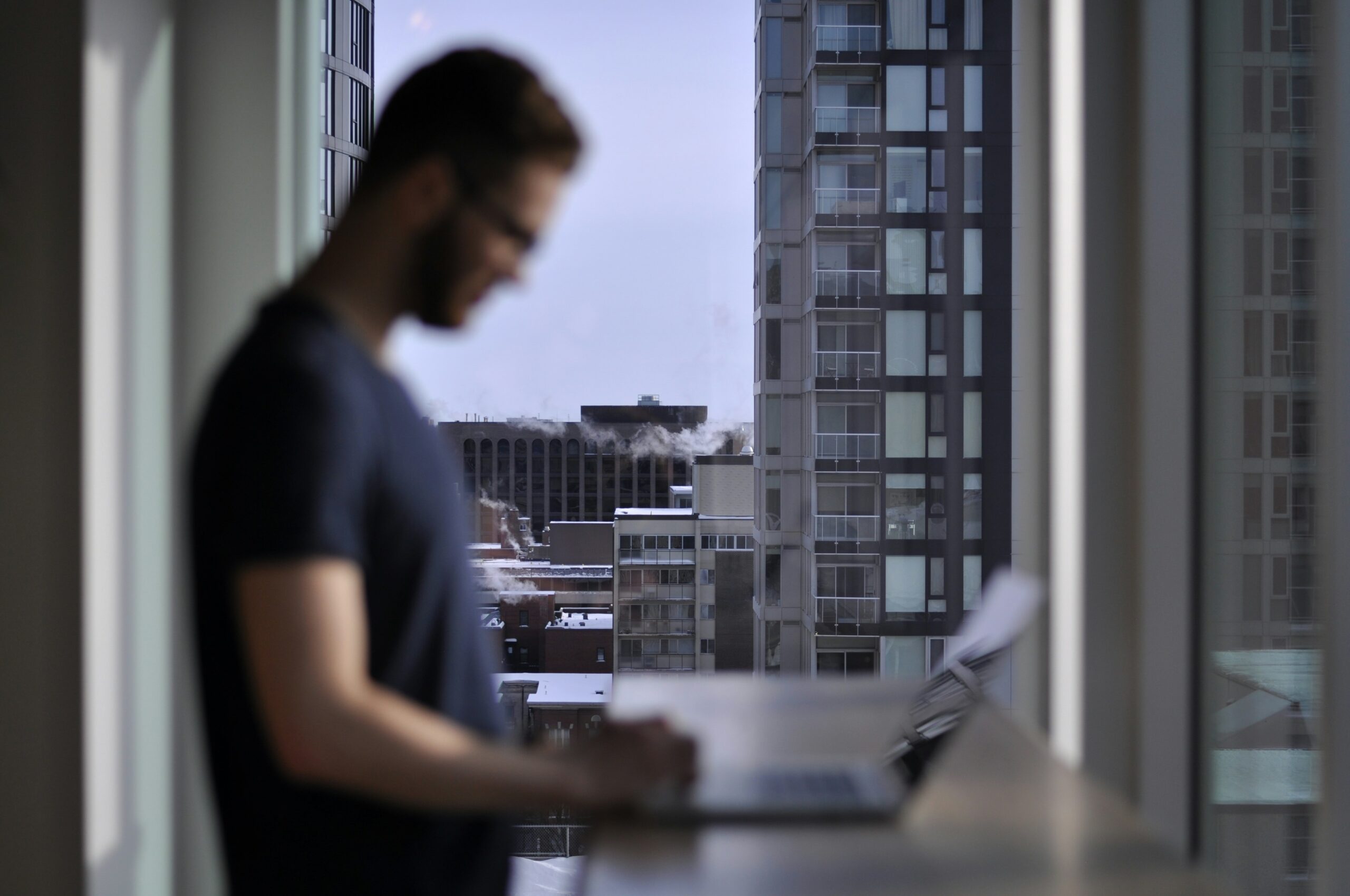 man standing while laptop computer