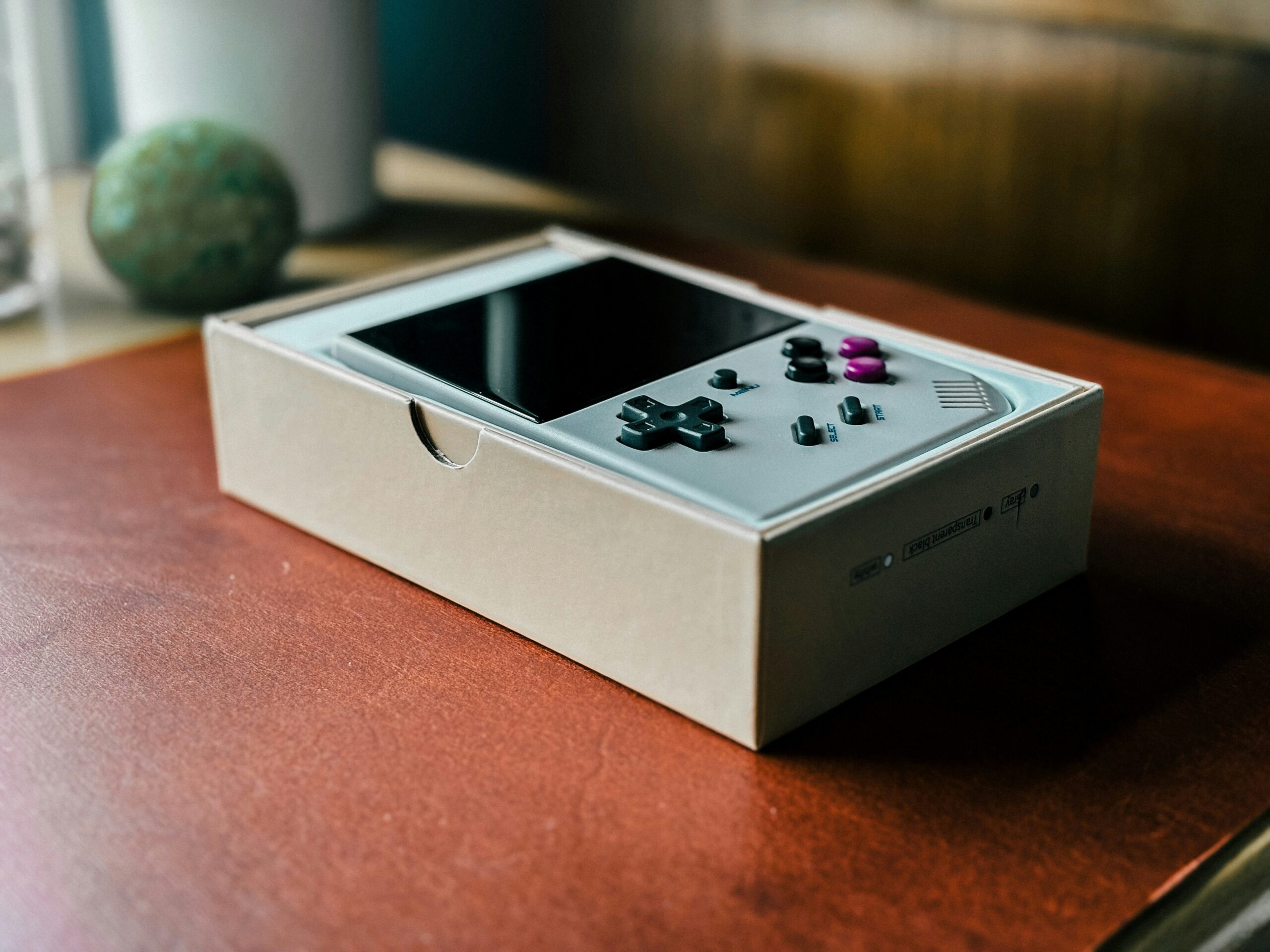 A nintendo wii controller sitting on top of a wooden table