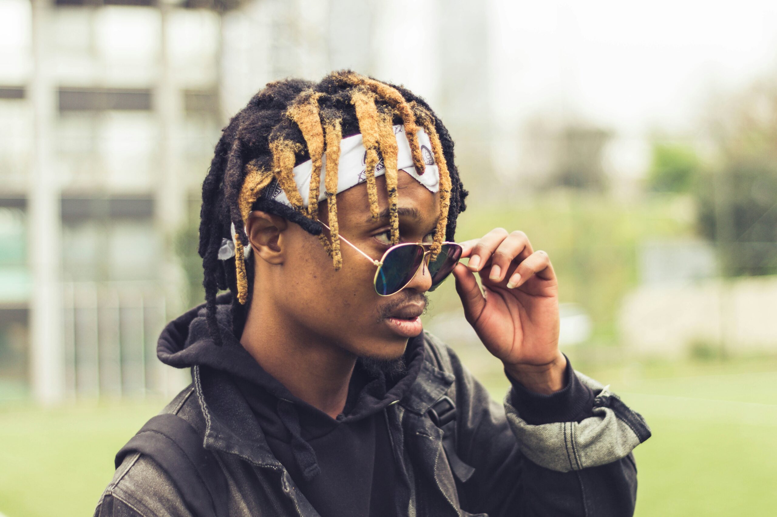 man in black leather jacket wearing black sunglasses